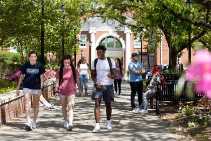 Students walking in front of Maugans with Allen Hall behind