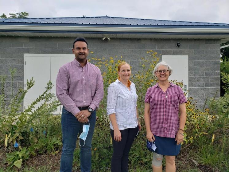 The new biology and environmental sciences faculty standing in front of the Environmental Education Center 