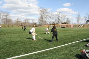 students playing field hockey