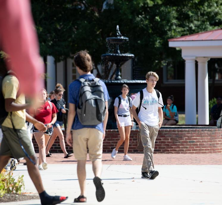 Students walking around the Rotunda fountain