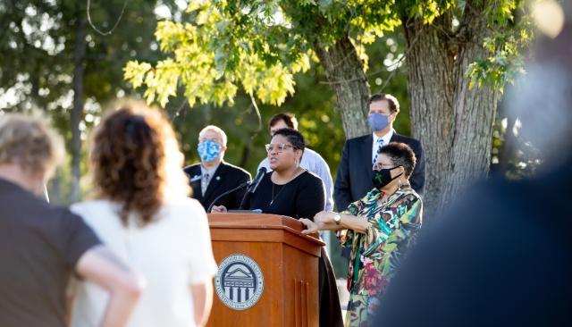 Megan Clark ’05, commonwealth’s attorney for Prince Edward County, gives her remarks beside her mother, Dr. Theresa Clark, M.S. ’88, now retired, who was a member of the social work faculty for more than 30 years and served as department chair.